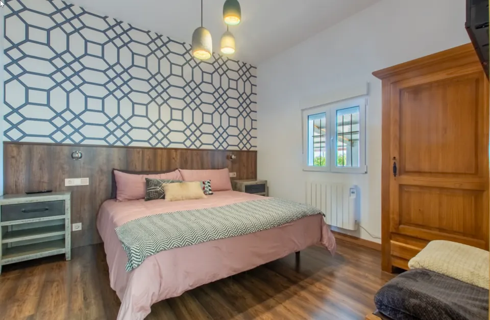 Dormitorio principal con papel geométrico